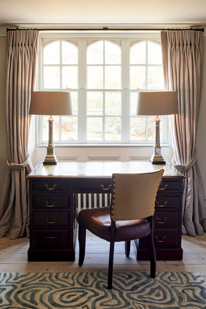 a living room filled with furniture and a large window