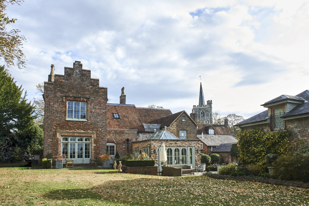 a large brick building with grass and trees