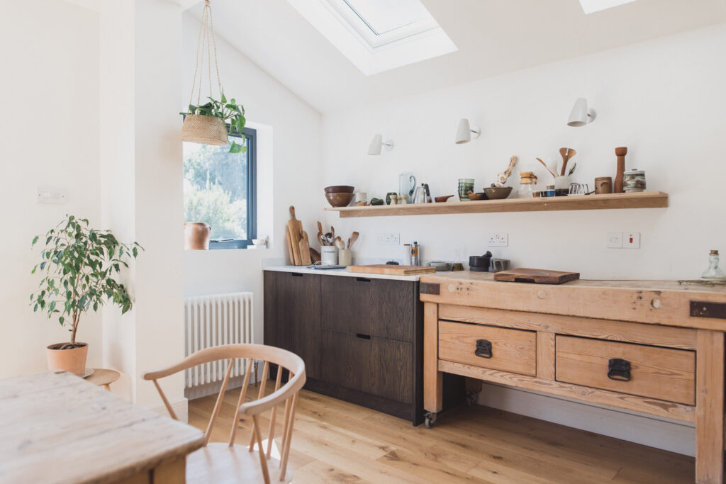 a kitchen with wooden cabinets and a dining room table