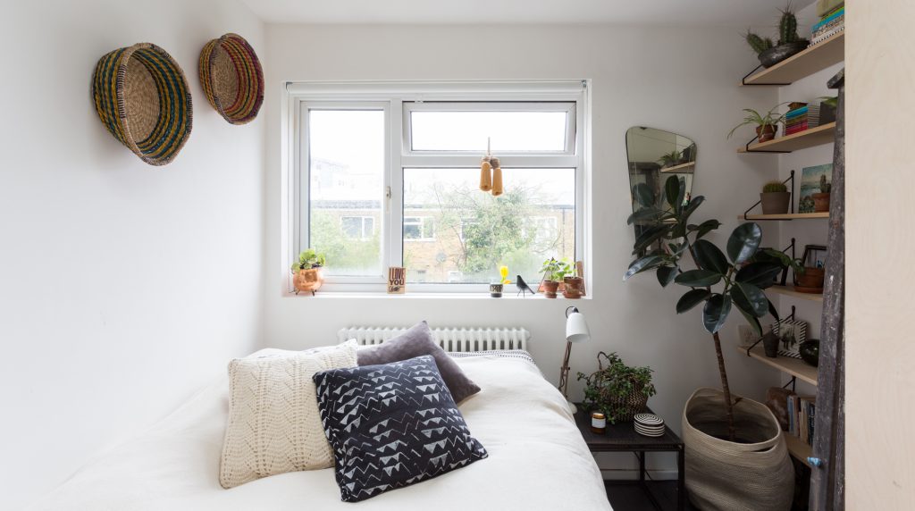 a living room with a bed and a mirror