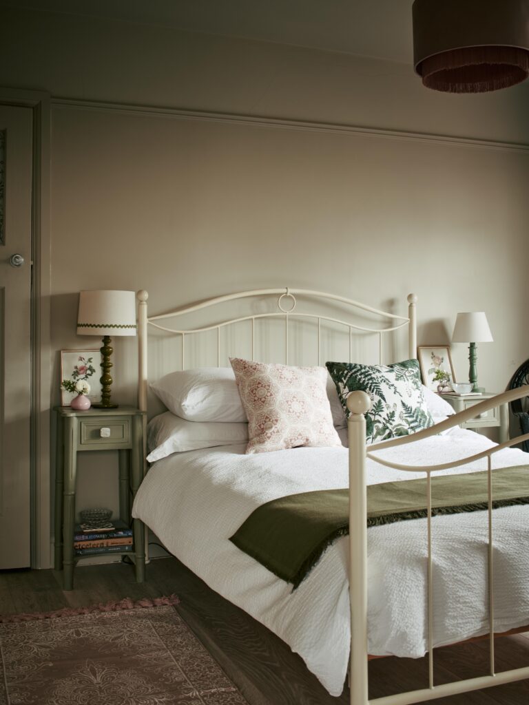 a bedroom with a bed and a chair in a room