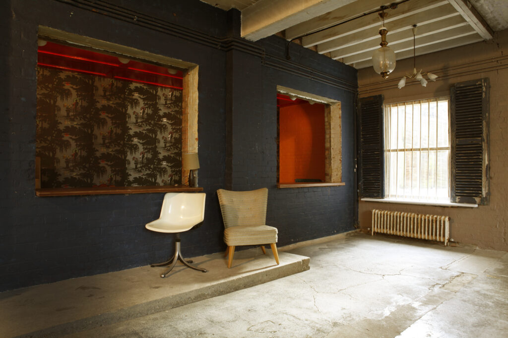 a living room filled with furniture and a large window