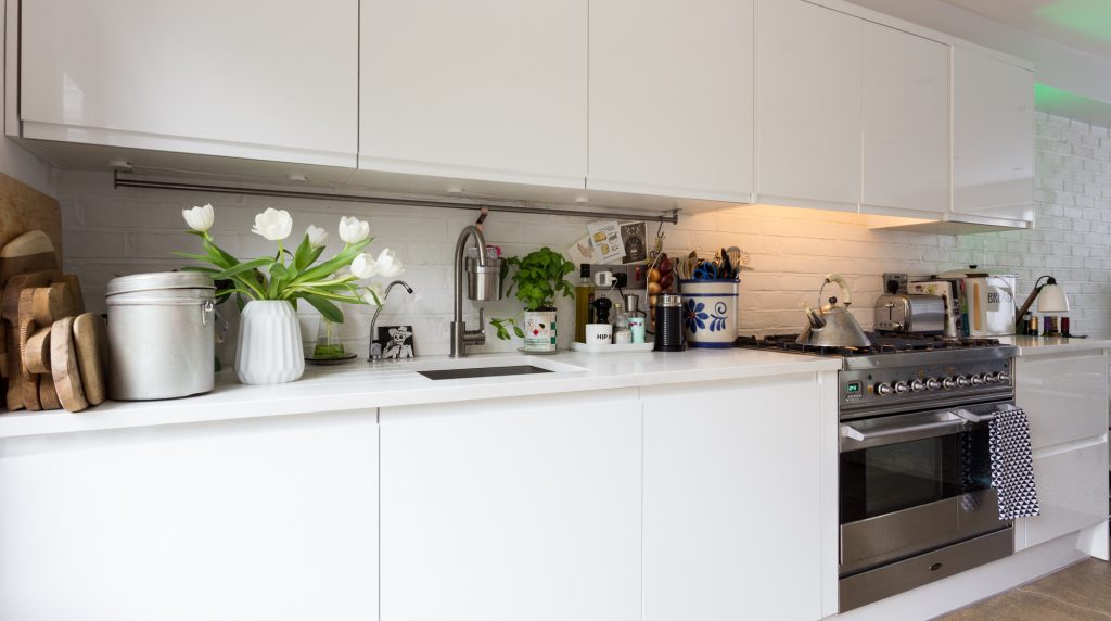a stove top oven sitting inside of a kitchen