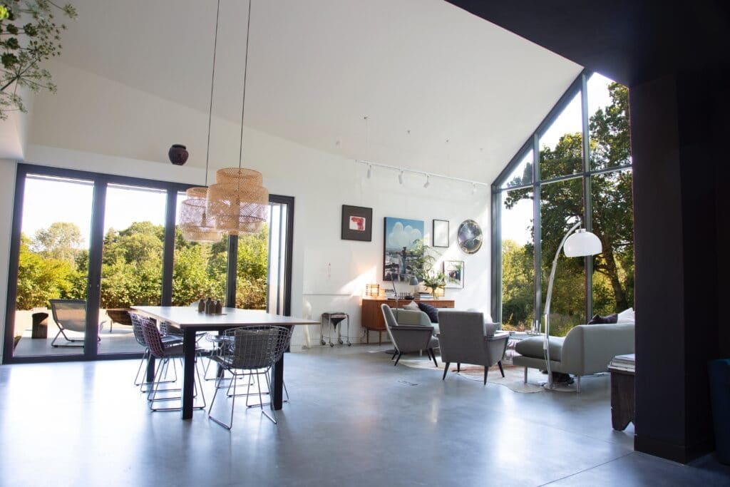 a living room filled with furniture and a large window