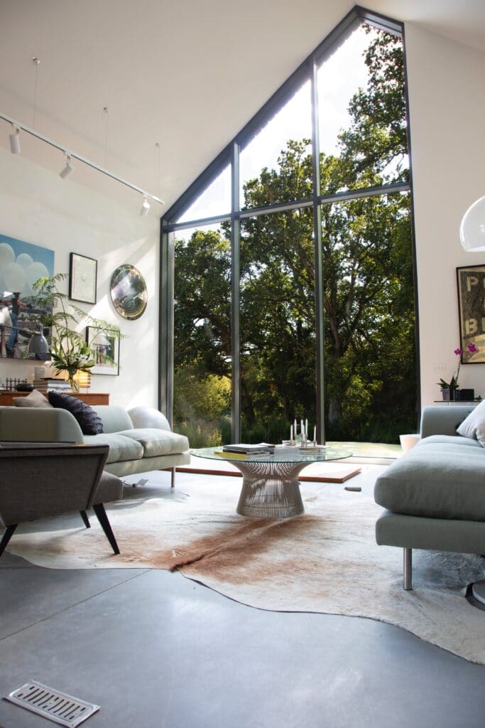 a living room filled with furniture and a large window