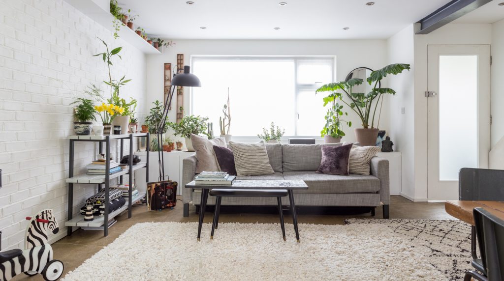 a living room filled with furniture and vase