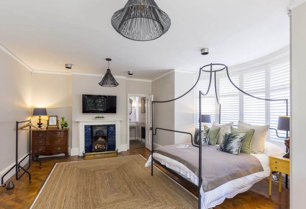 a bedroom with a bed and desk in a room