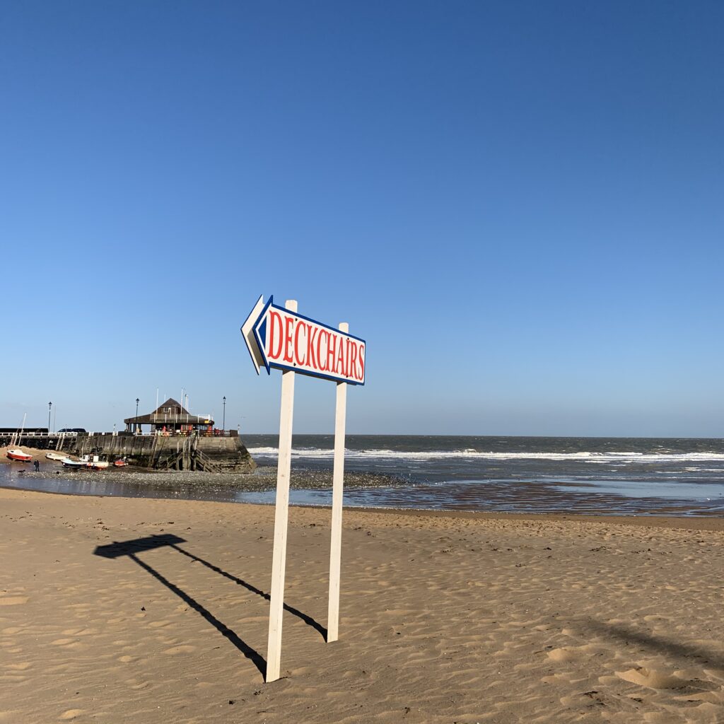 a sign on a sandy beach