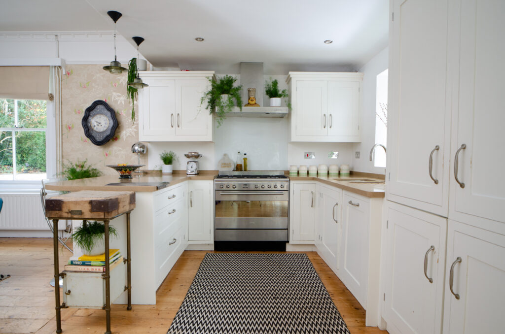 a kitchen with a sink and a chair in a room