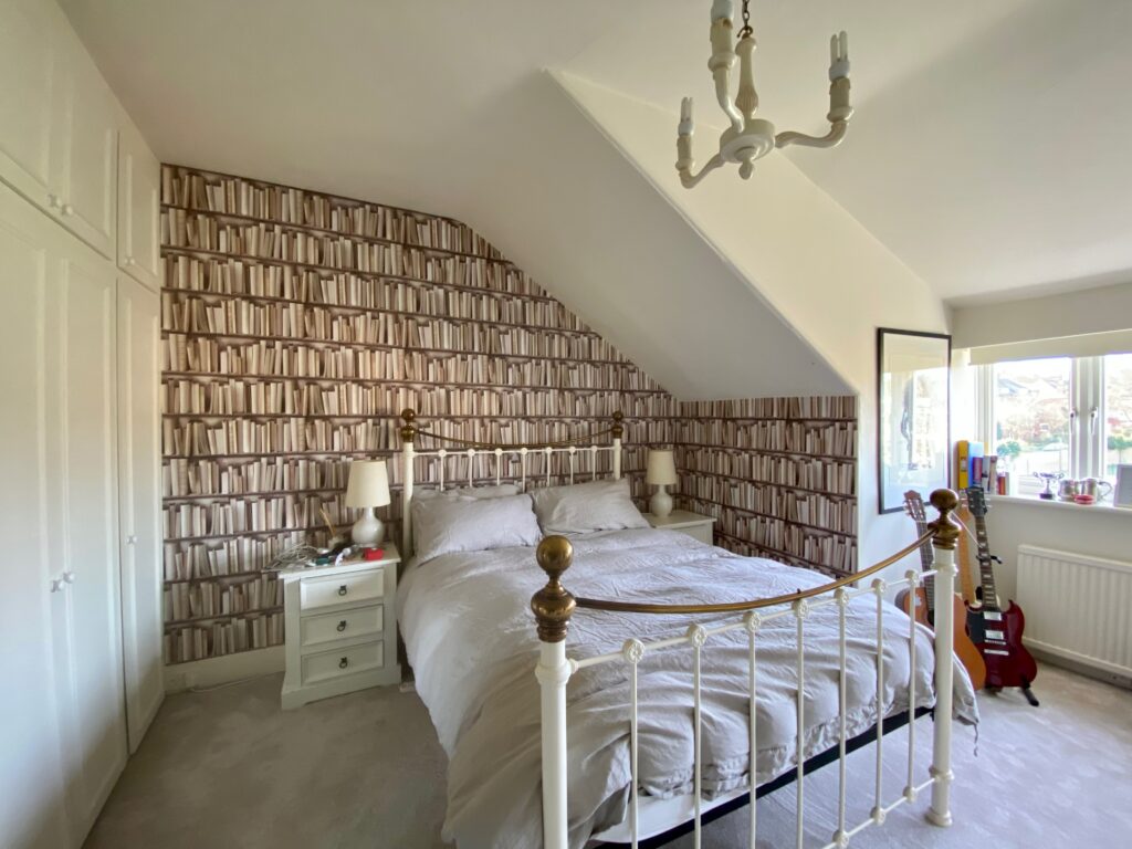 a bedroom with a bed in a room