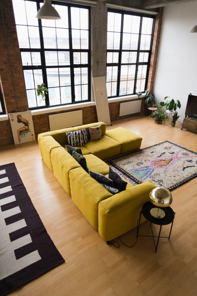 a living room filled with furniture and a window