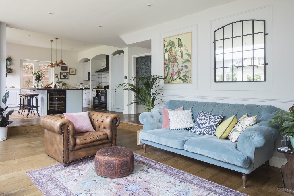 a living room filled with furniture and a large window