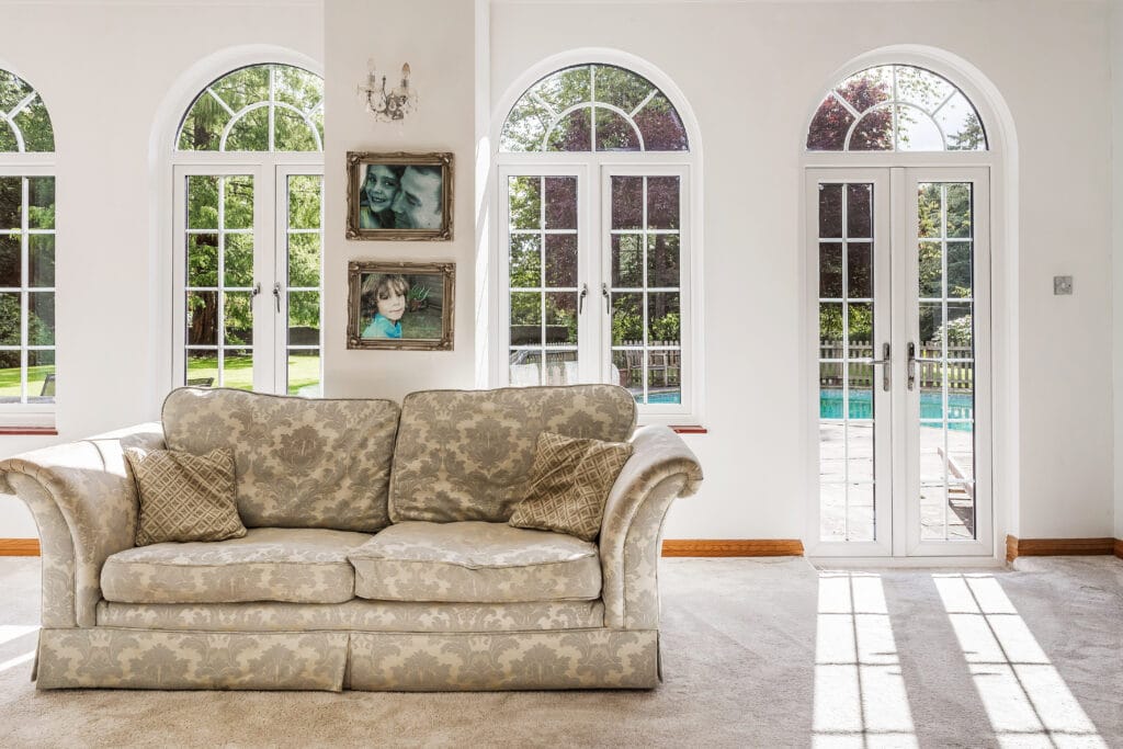 a living room filled with furniture and a large window