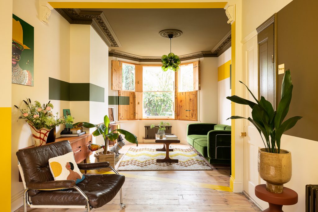 a living room filled with furniture and vase of flowers on a table