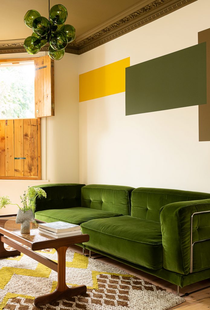 a living room filled with lots of green leaves