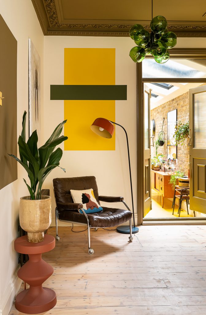 a living room filled with furniture and vase of flowers on a table