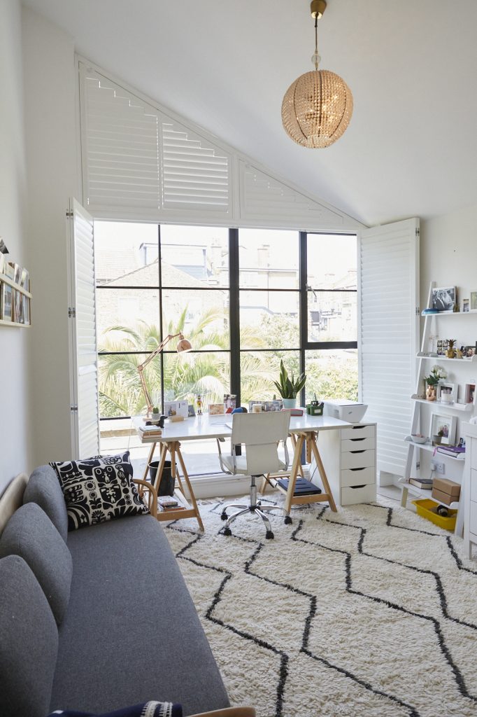 a living room filled with furniture and a large window
