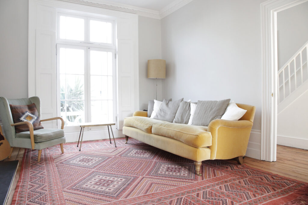 a living room filled with furniture and a large window