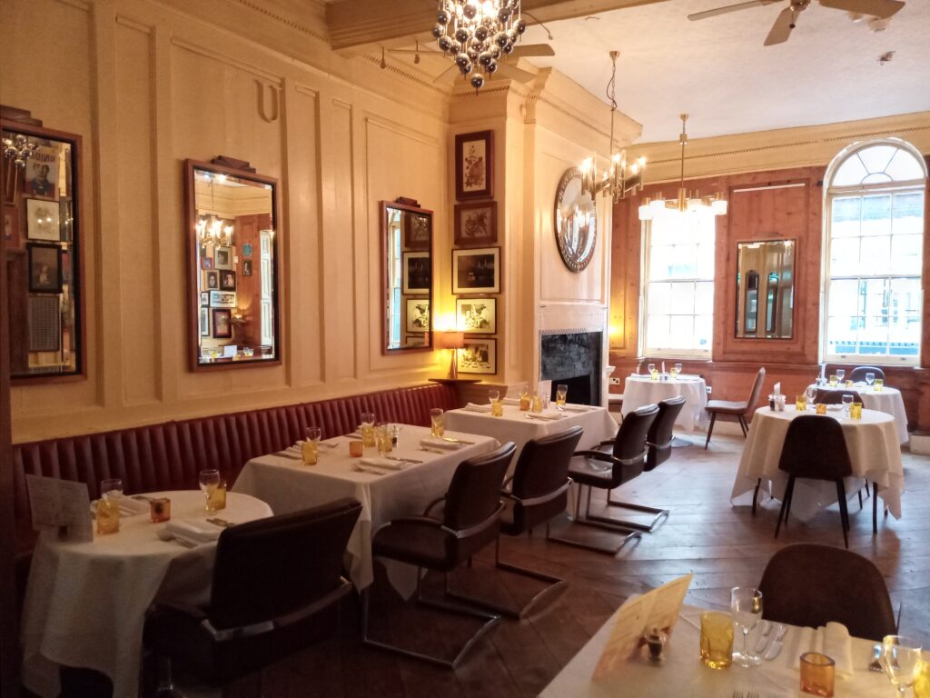 a room filled with furniture and a fire place and a dining table