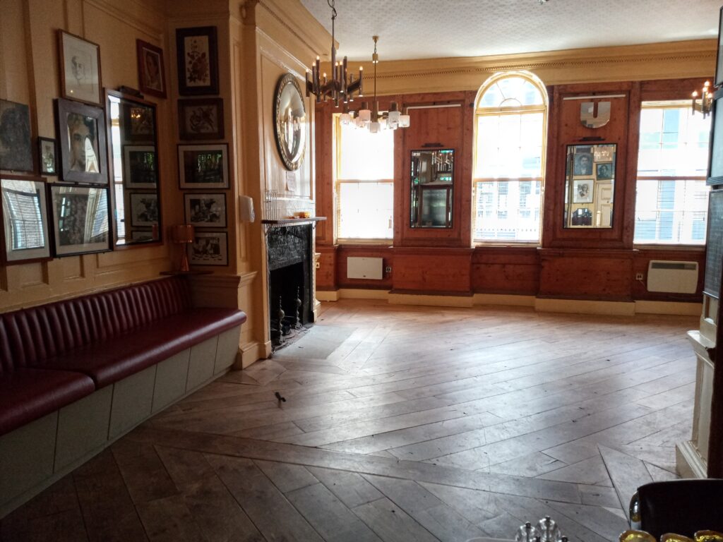 a room with a fireplace and a large window