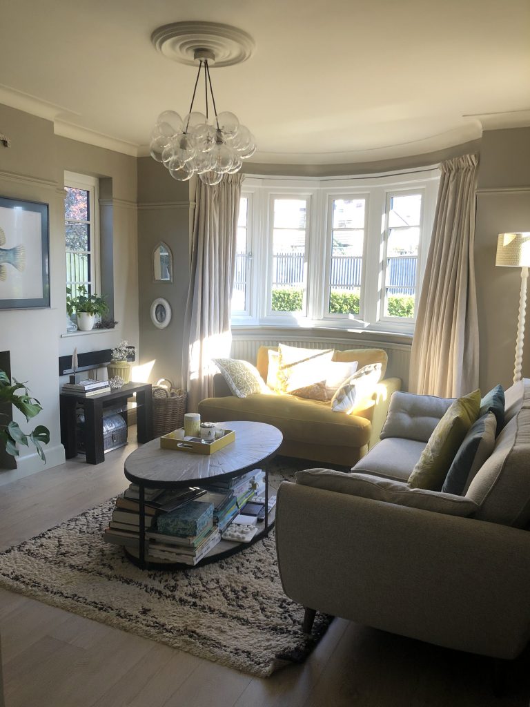 a living room filled with furniture and a large window