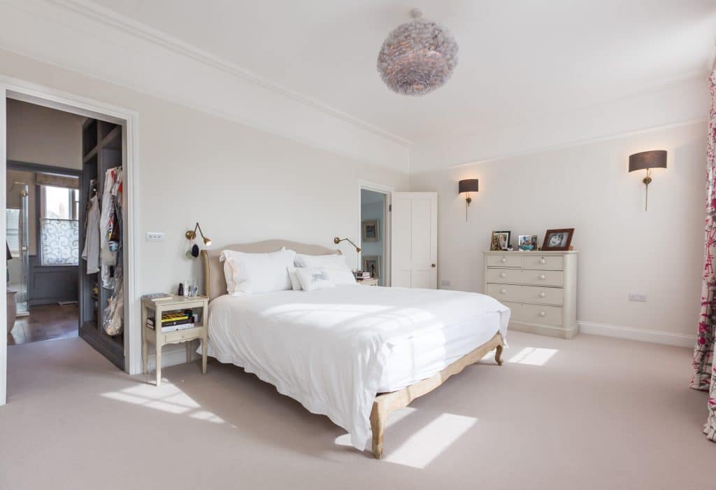 a bedroom with a bed in a room