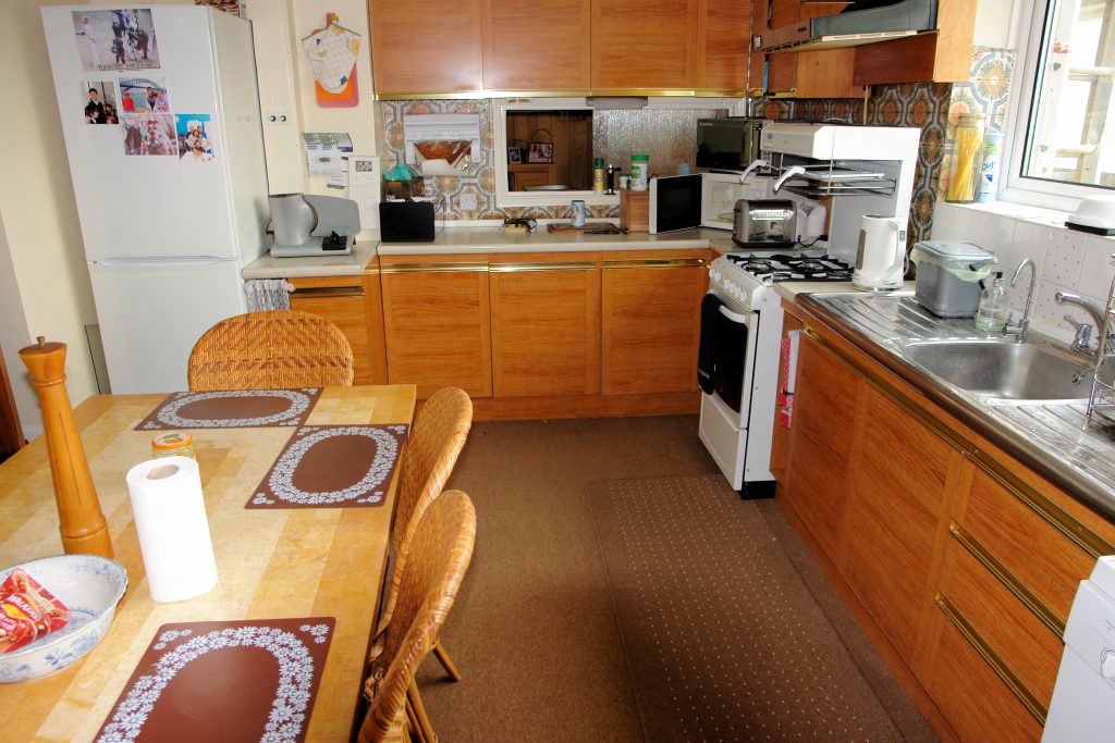 a kitchen with a table and looking at the camera