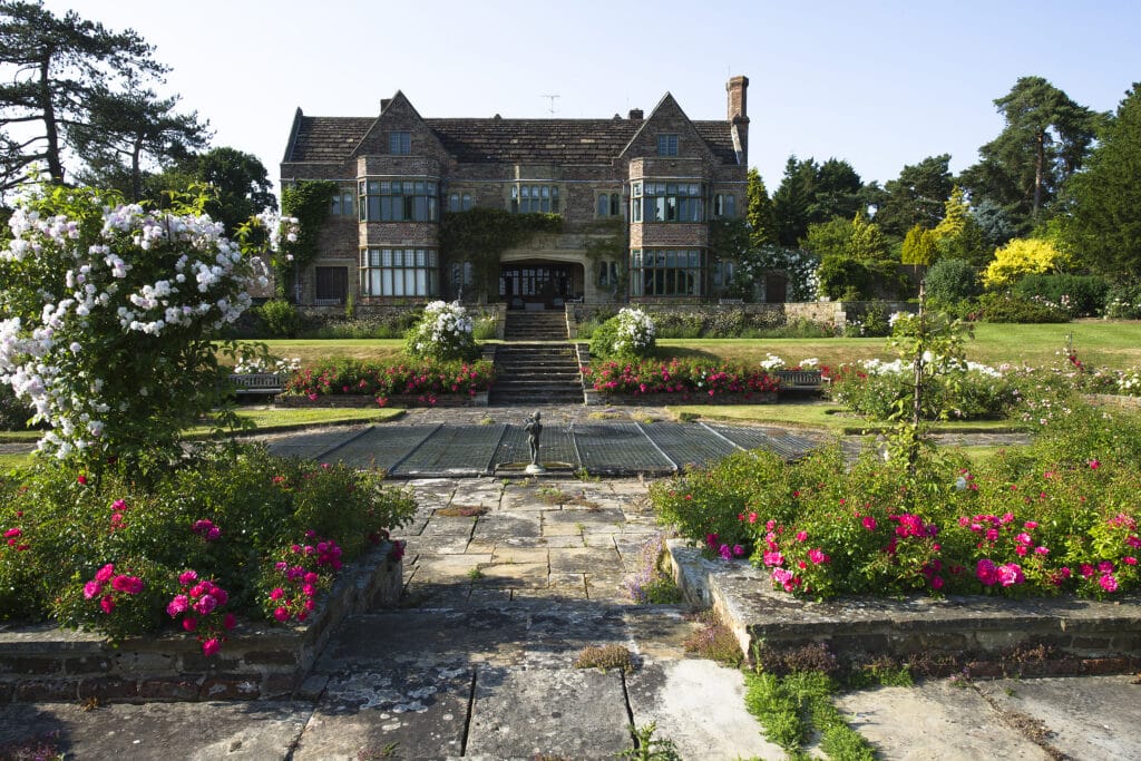 a close up of a flower garden in front of a building