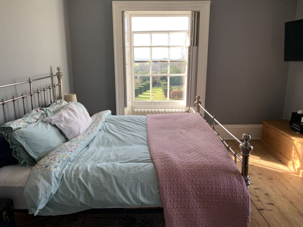 a bedroom with a bed and a window