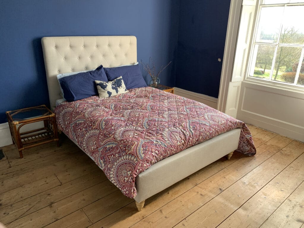 a bedroom with a bed and a window