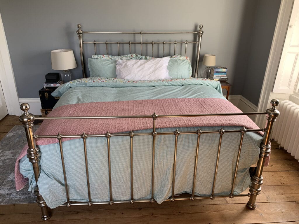 a bedroom with a bed and a chair in a room