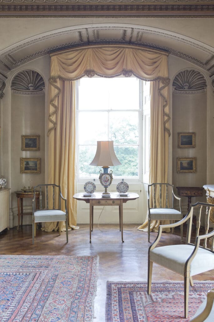 a living room filled with furniture and a large window