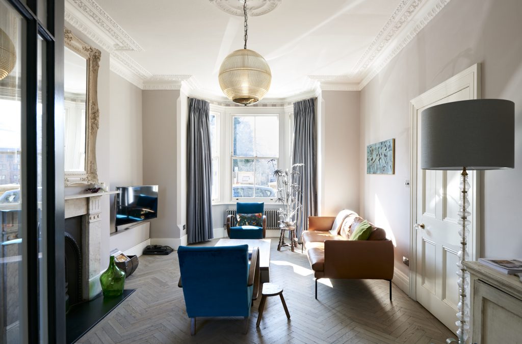 a living room filled with furniture and a large window