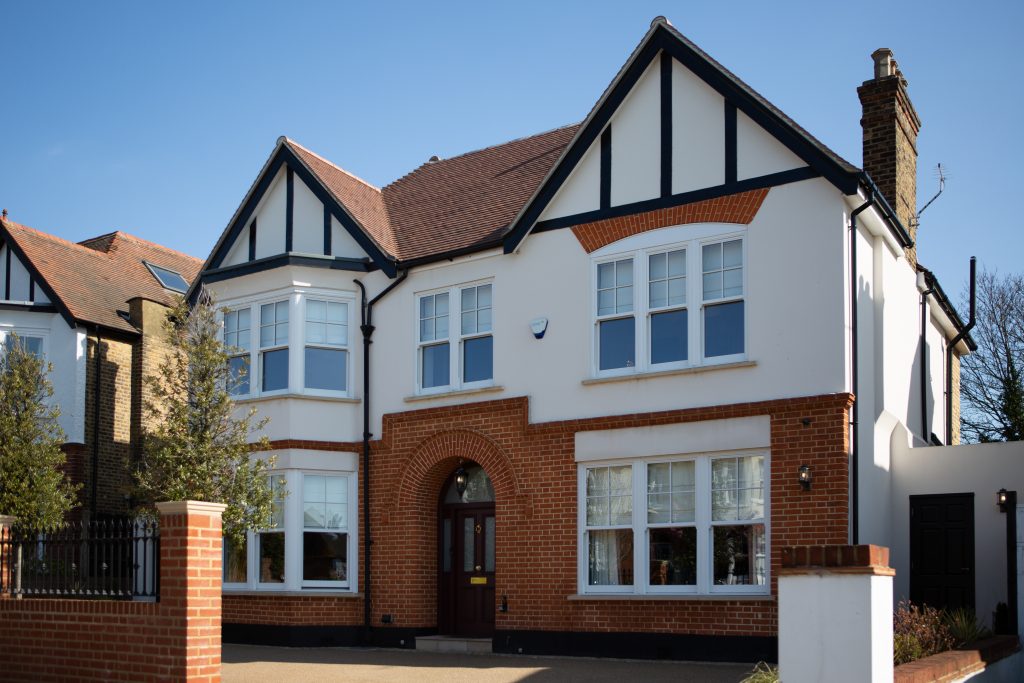 a house in front of a brick building