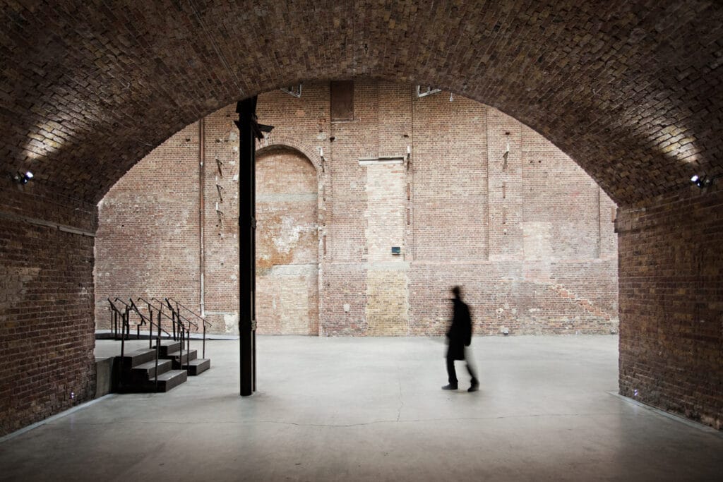 a person walking in front of a brick building