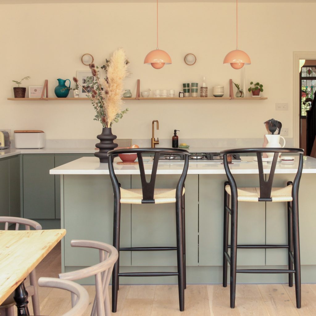 a kitchen with a table and chairs in a room