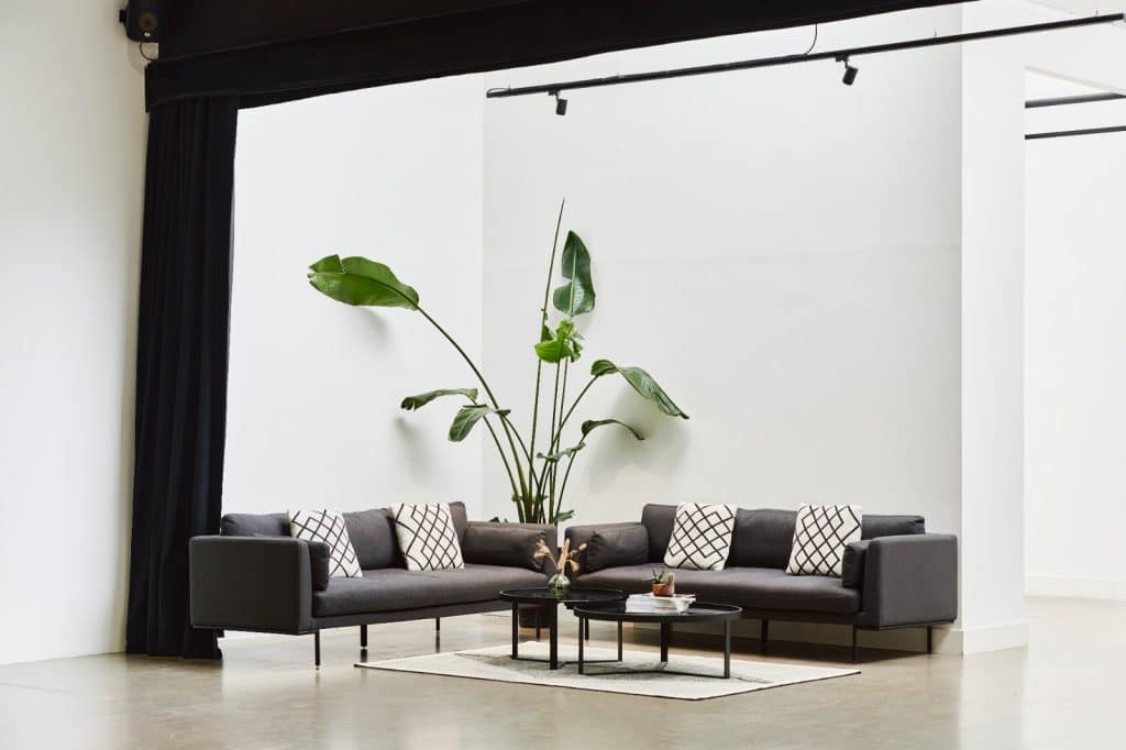 a room filled with furniture and vase of flowers on a table