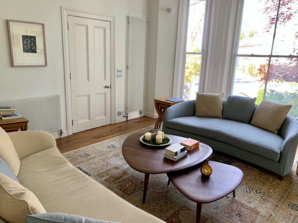 a living room filled with furniture and a large window