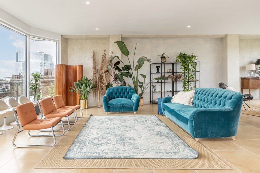 a living room filled with furniture and a large window