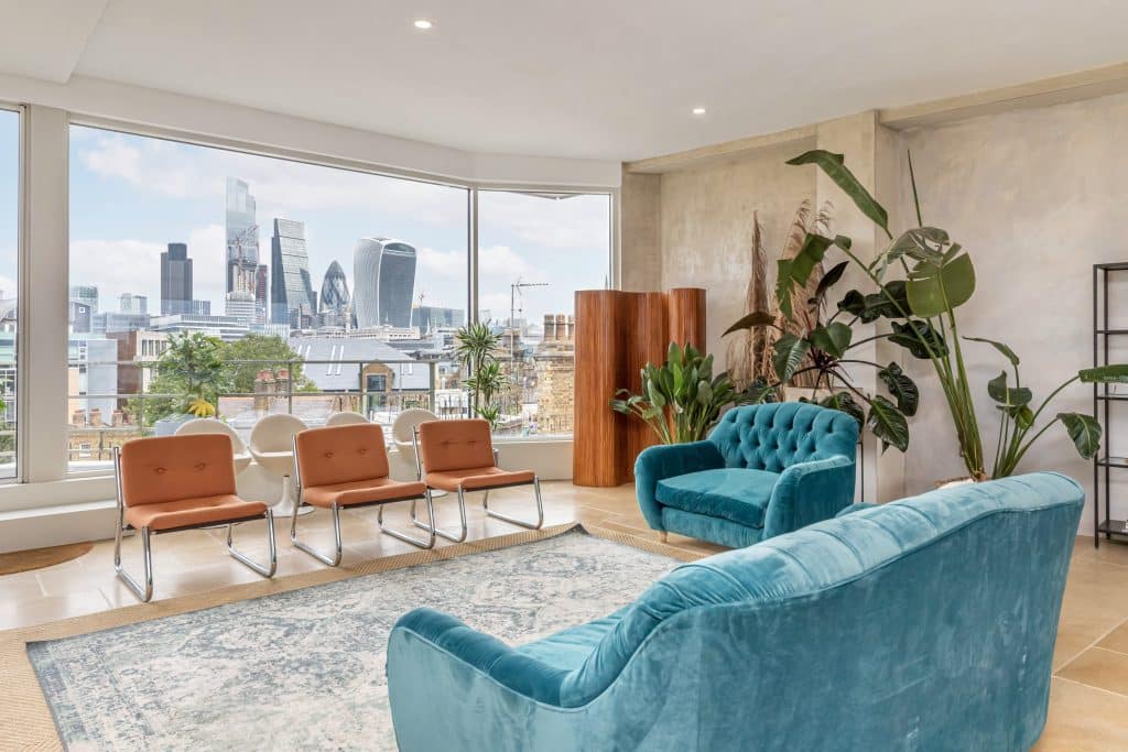 a living room filled with furniture and a large window