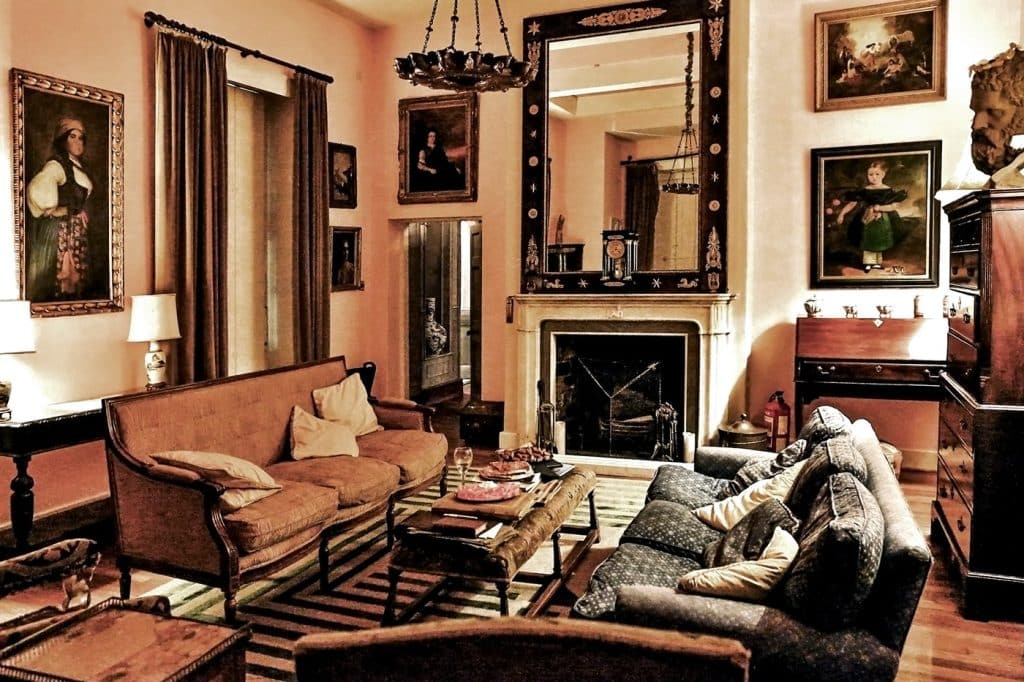 a living room filled with furniture and a fire place sitting in a chair