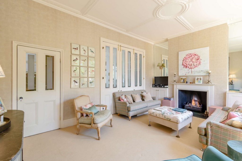 a living room filled with furniture and a fireplace