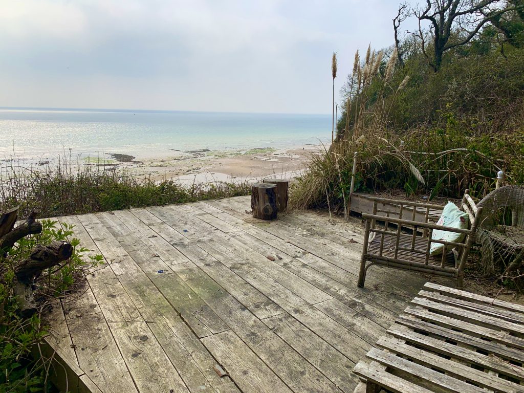 a wooden bench next to a body of water