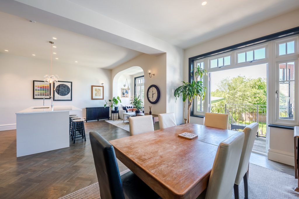 a living room filled with furniture and a large window