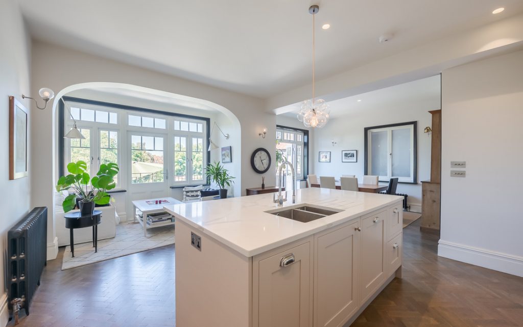 a kitchen with a wood floor in a room