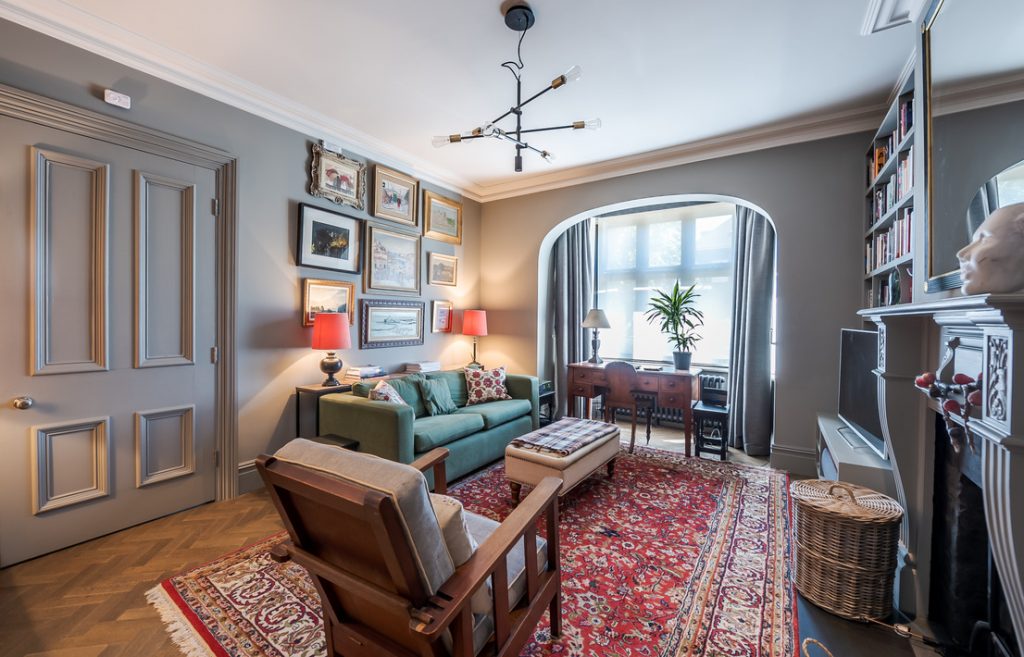a living room filled with furniture and a large window