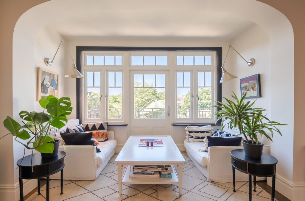 a living room filled with furniture and a large window