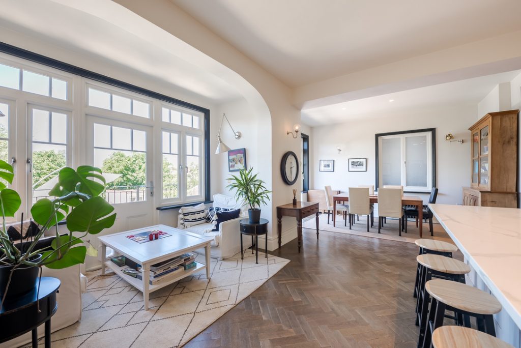 a living room filled with furniture and a large window