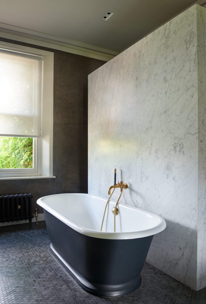 a large tub next to a window