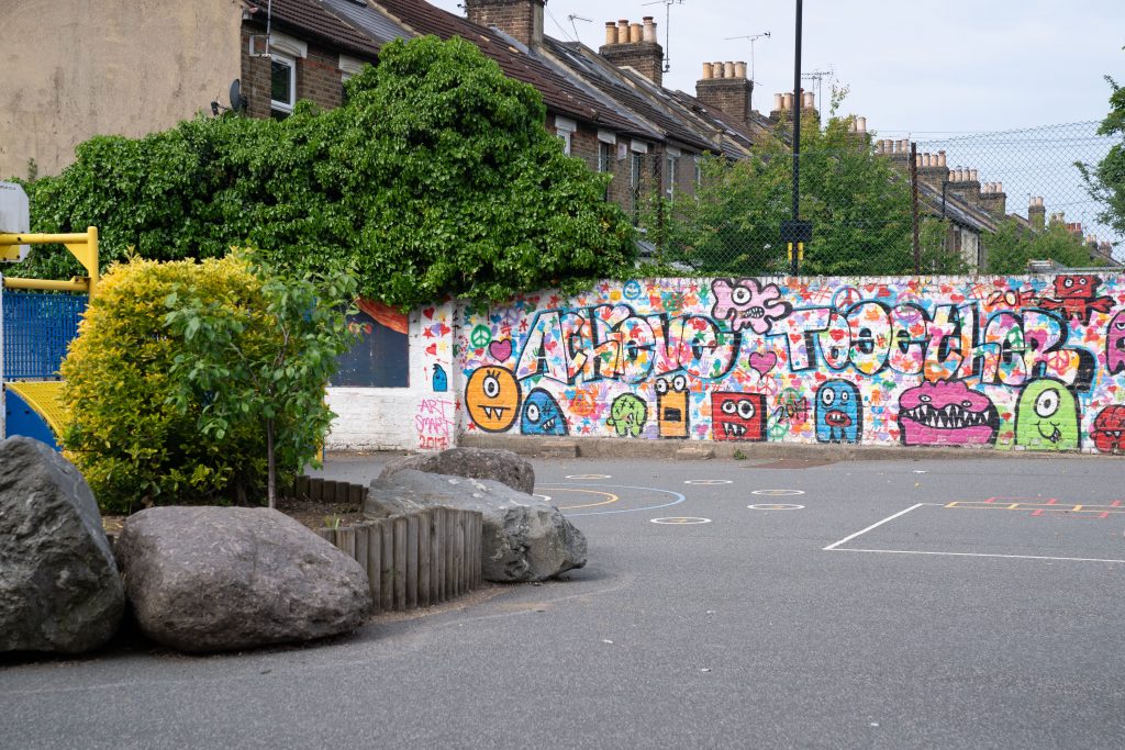 a building with graffiti on the side of a road